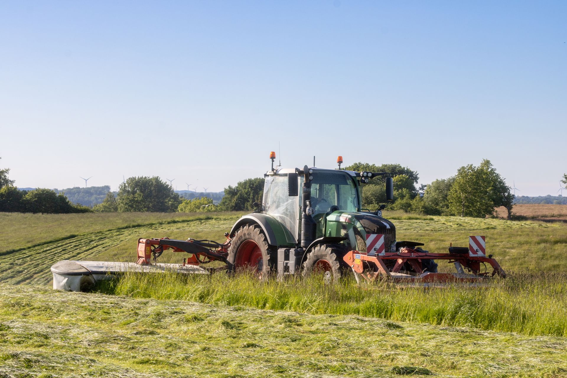 Farm tractor operating across open agricultural land